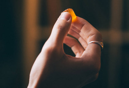 A hand holding a Goodrays CBD gummy