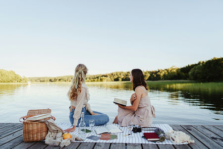 Two women having a picnic with drinks
